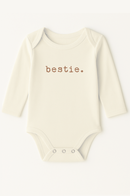 Baby onesie with 'bestie.' text on a white background
