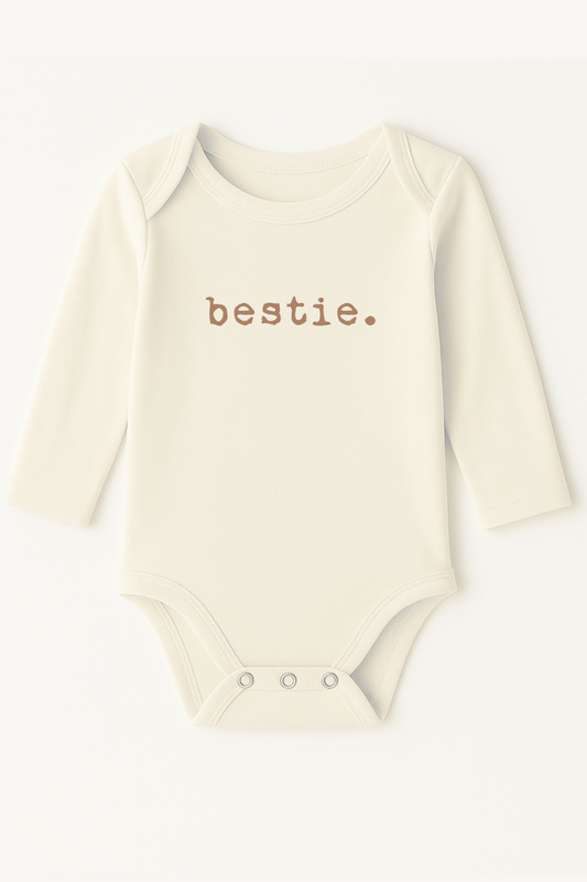 Baby onesie with 'bestie.' text on a white background